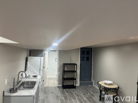 A kitchen with a sink and a refrigerator.