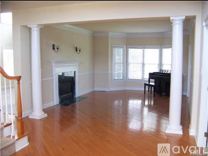 A living room with a fireplace and a dining table.