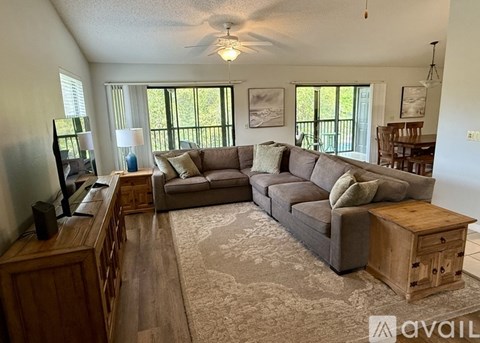 A living room with a grey sofa and a wooden coffee table.