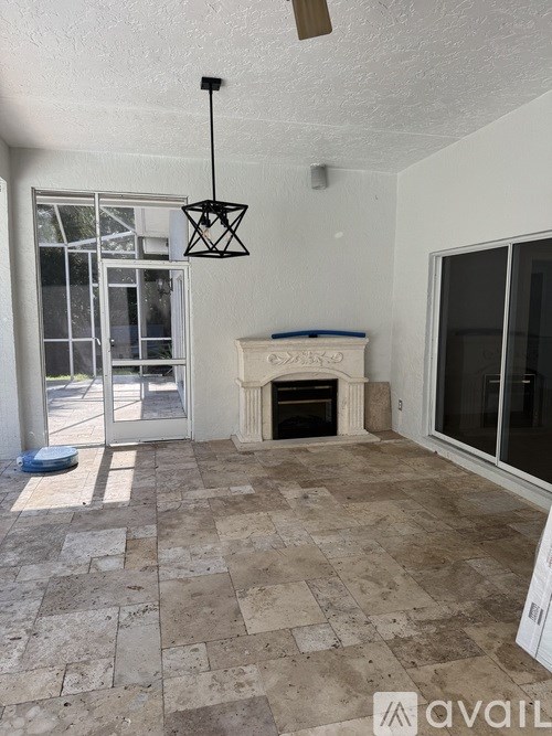 A room with a fireplace and a fan.
