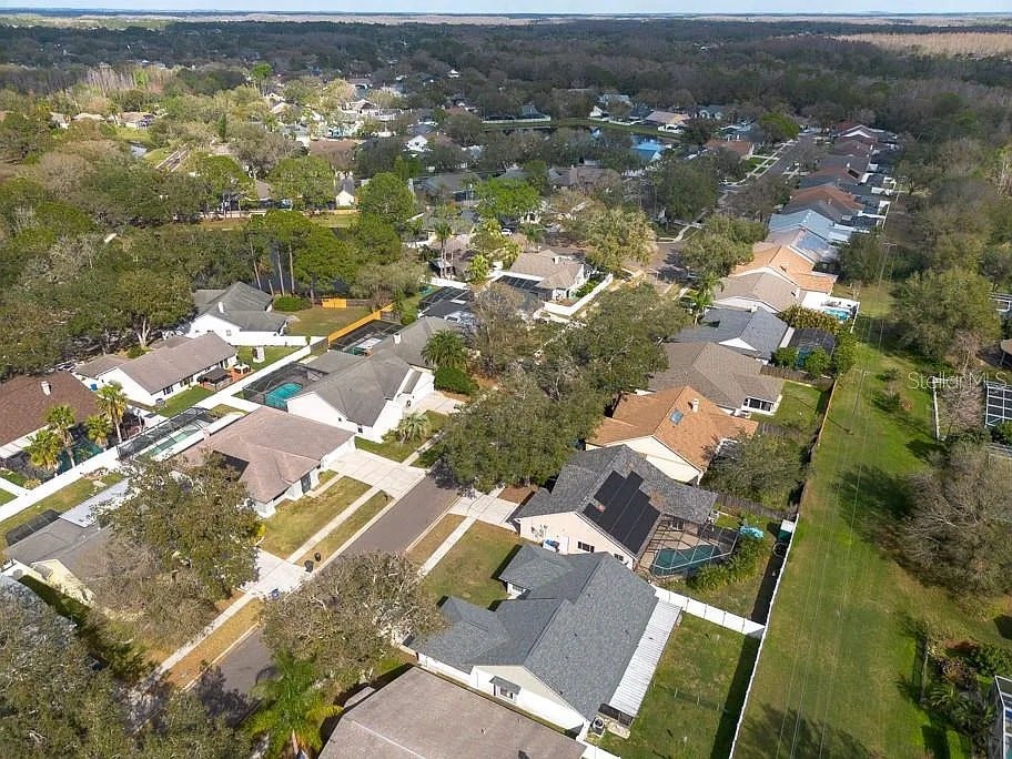 A bird's eye view of a residential neighborhood with houses and trees.