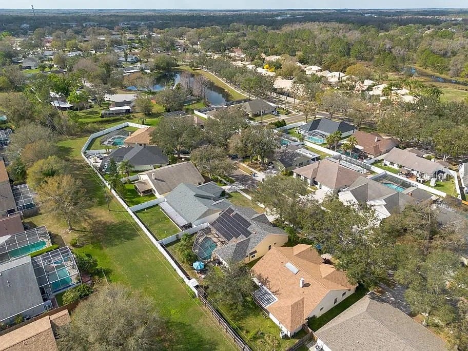 A bird's eye view of a residential area with houses and green spaces.