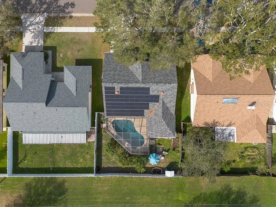 A house with a green lawn and a swimming pool.