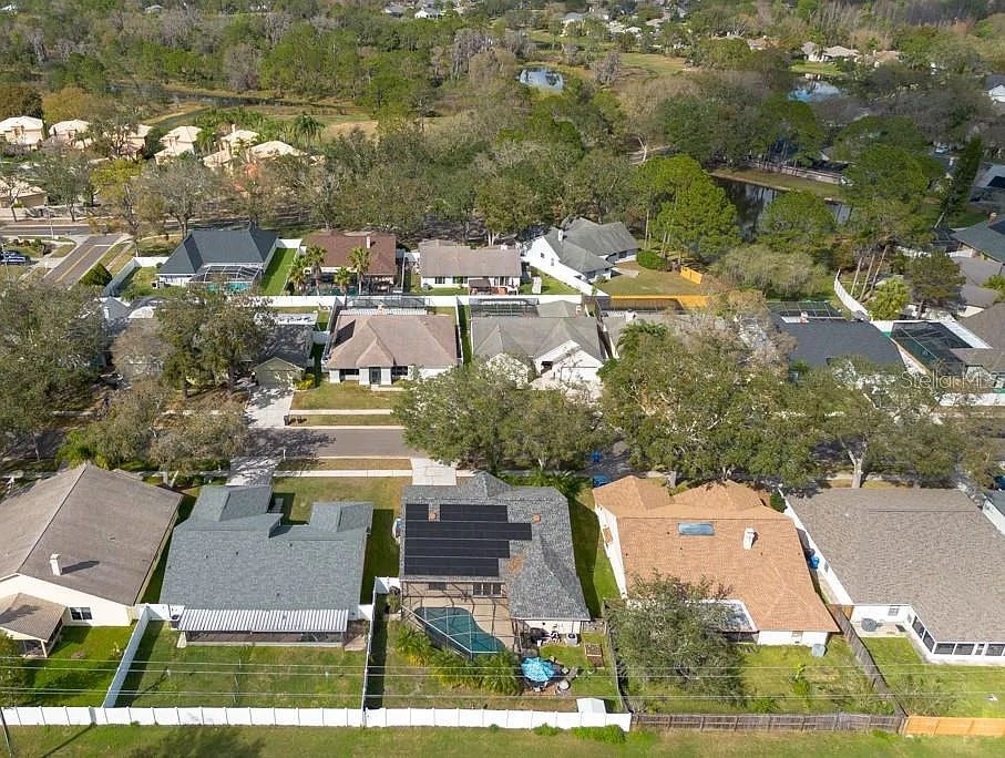 A bird's eye view of a residential neighborhood with houses and trees.