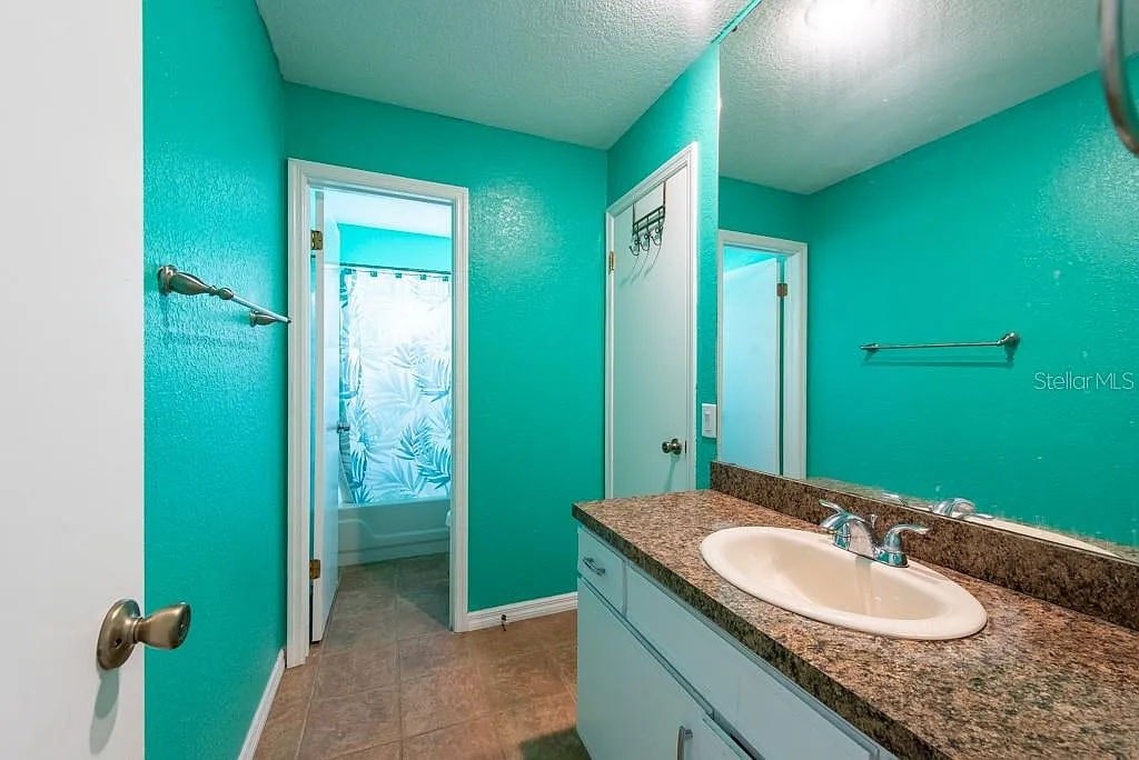A bathroom with a sink and mirror.