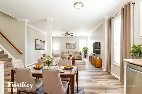 A well-lit dining room with a table set for a meal.