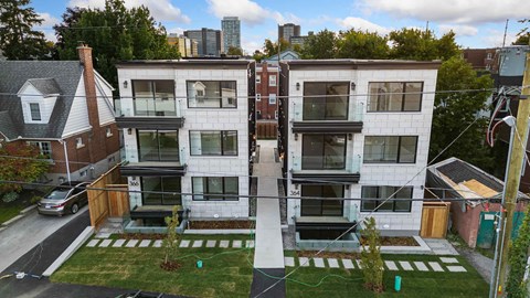 Two modern apartment buildings are shown in the image.