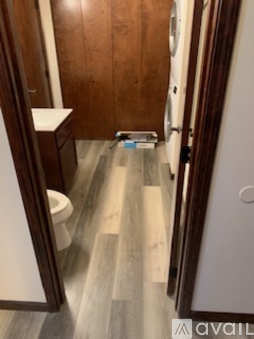 A bathroom with a toilet, sink, and mirror.