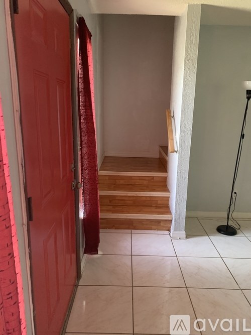 A kitchen with a sink, stove, and cabinets.
