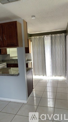 A kitchen with a white refrigerator, white microwave, and white oven.