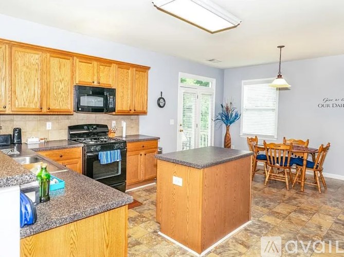 A kitchen with wooden cabinets and a granite countertop.