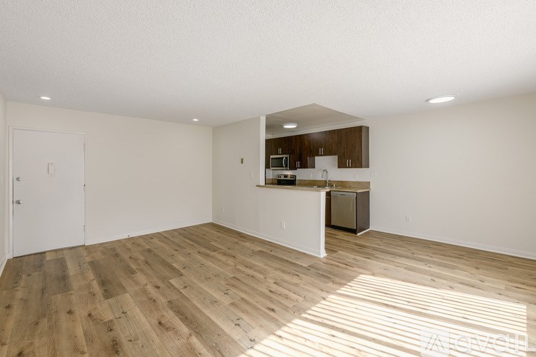 A kitchen area with a refrigerator, microwave, and oven.
