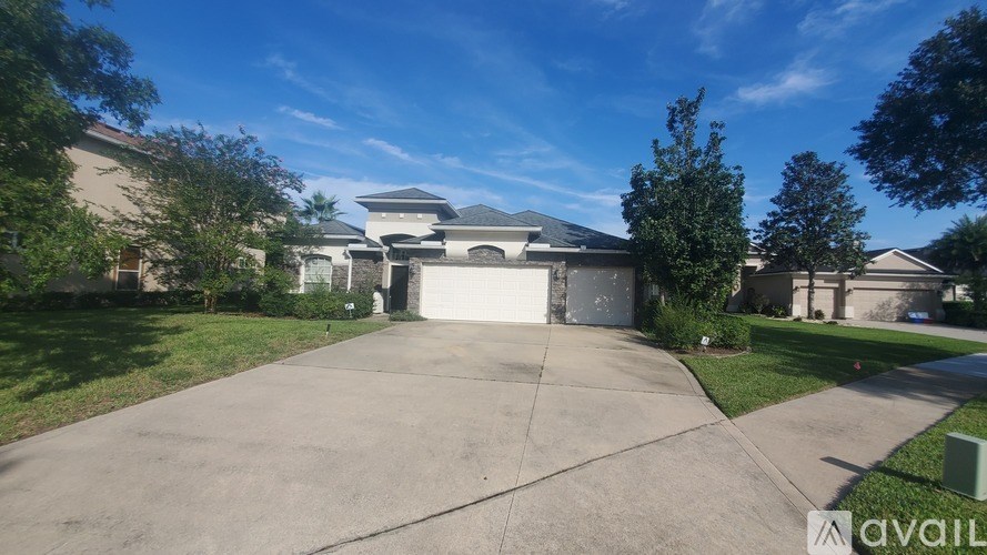 A house with a driveway and garage is for sale.