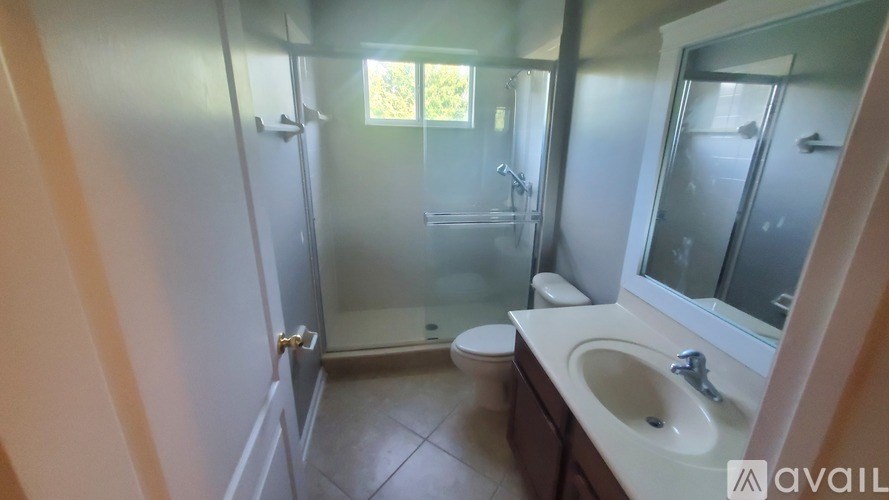 A bathroom with a sink, toilet, and shower.