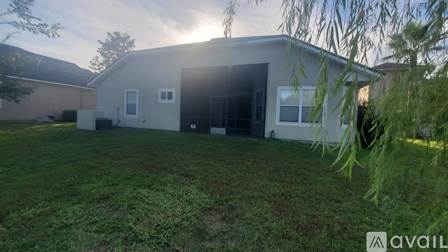 A modern house with a large yard is available for rent.