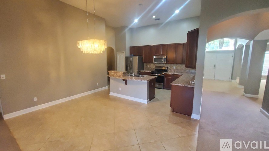 A spacious kitchen and living room with a large island in the middle.