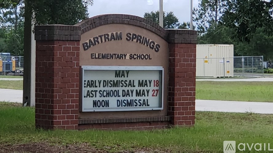 A sign for Bartram Springs Elementary School with early dismissal and last day of school information.