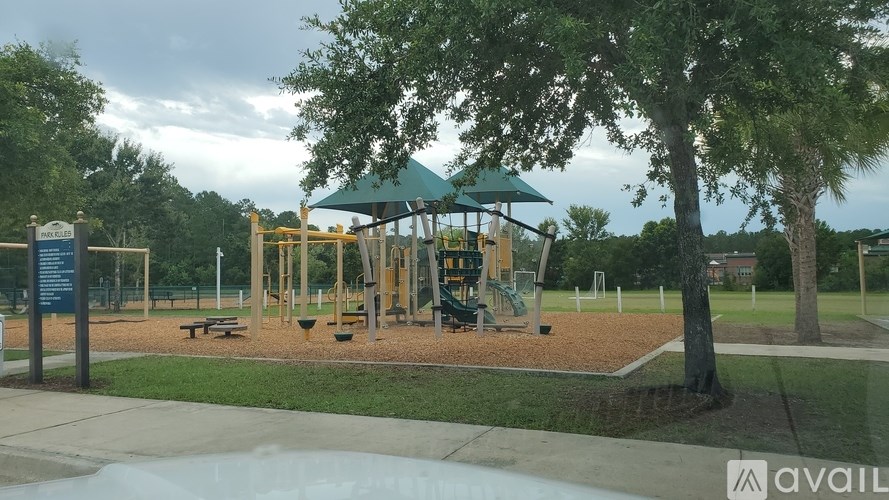 A playground with a green canopy and a slide.
