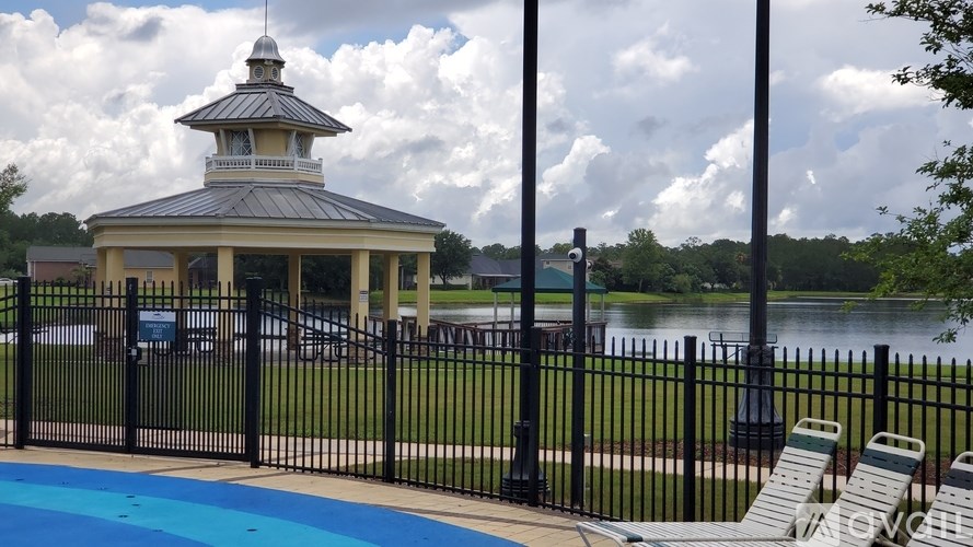 A gazebo is situated next to a pool.