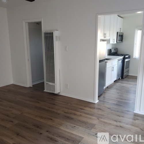 A kitchen with a white fridge and a white door.