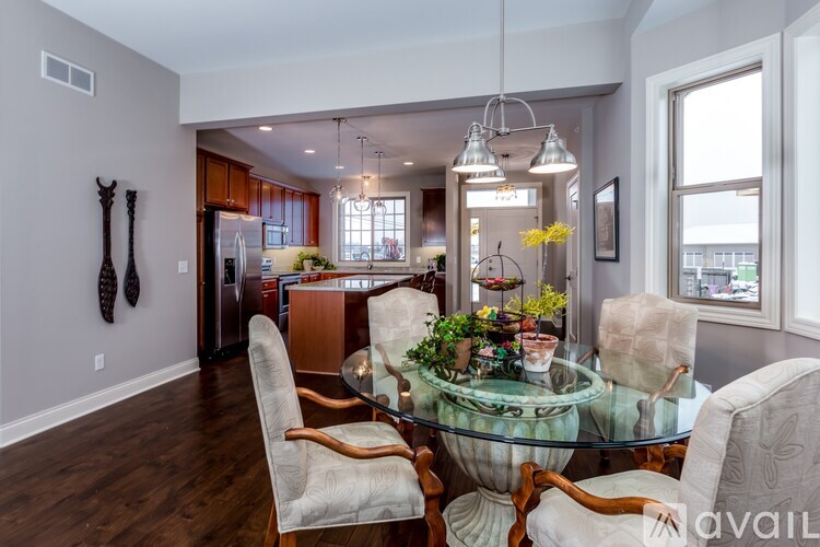 A modern dining room with a glass table and chairs.