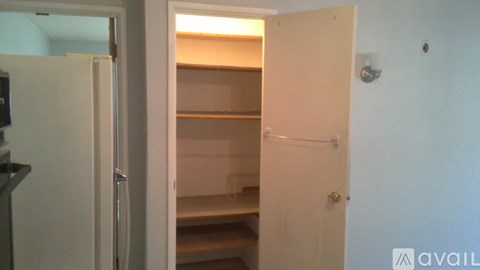 A white refrigerator is in a kitchen with a door open.