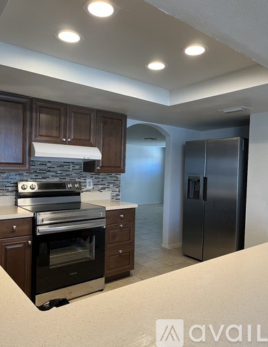 A kitchen with a stove, oven, and refrigerator.
