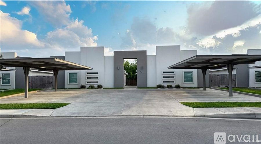 A modern building with a white facade and a large entrance.