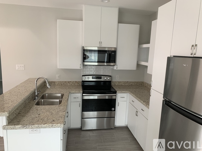 A kitchen with white cabinets and stainless steel appliances.