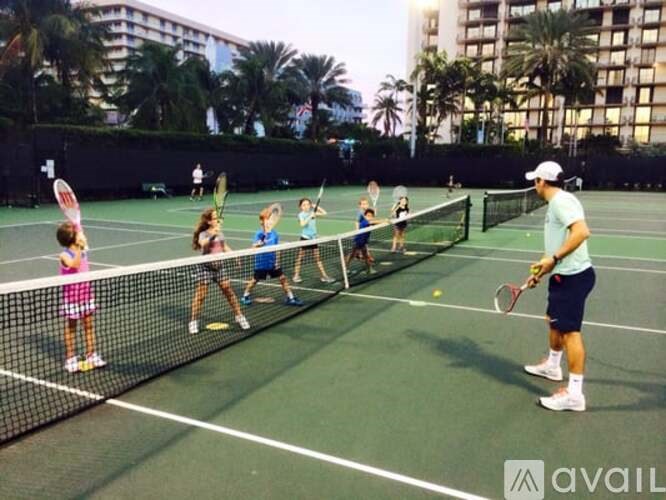 A group of people playing tennis on a court.