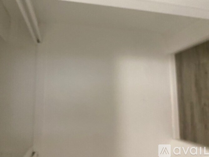 A white wall with a small hole in it.