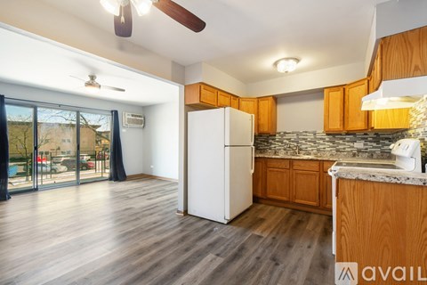 A kitchen with wooden cabinets and a white refrigerator.