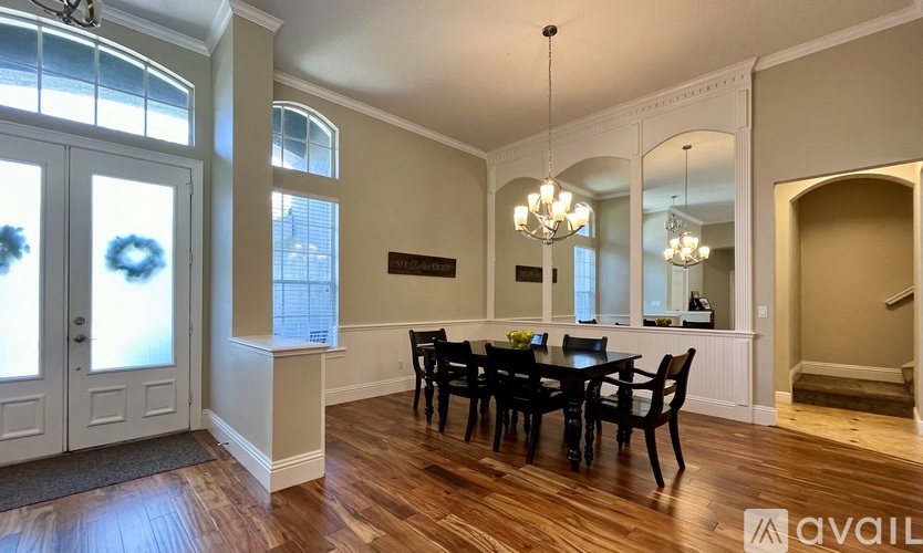 A dining room with a wooden table and chairs.