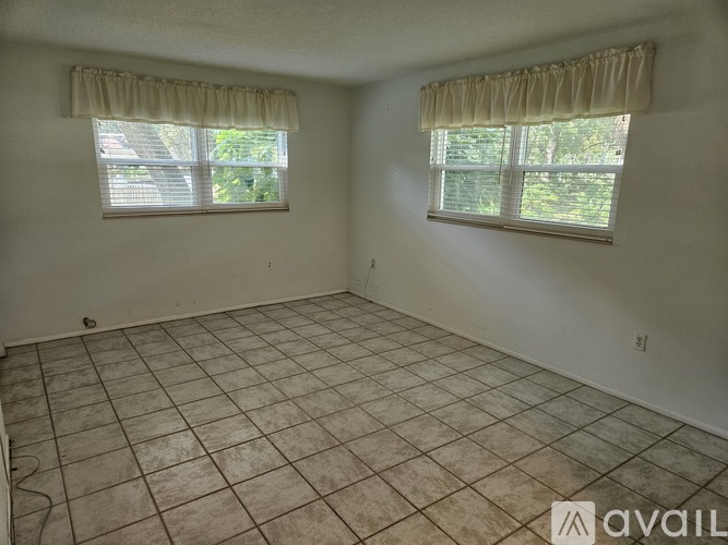 A bedroom with a bed, nightstand, and two lamps.
