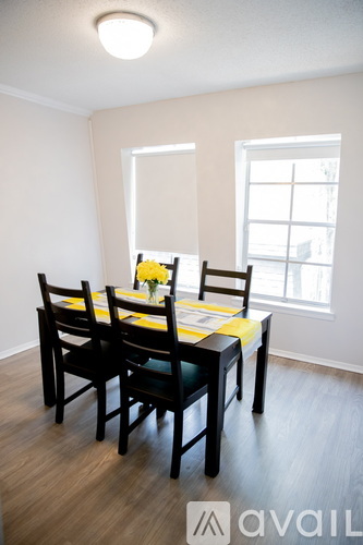 A dining room with a table set for four.