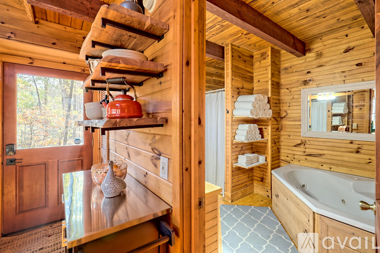 A wooden cabin with a hot tub and a window.