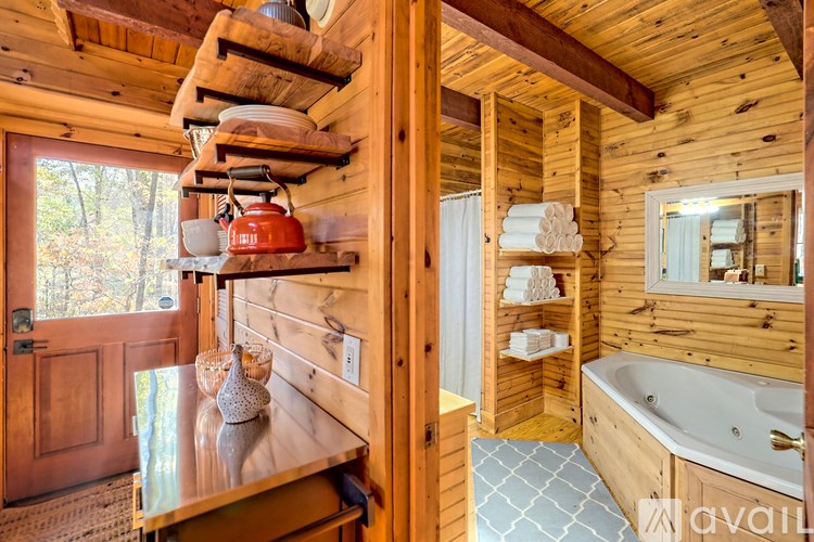 A wooden cabin with a hot tub and a window.