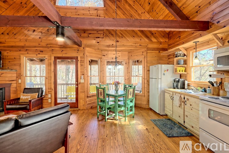 A wooden cabin with a kitchen and living room.
