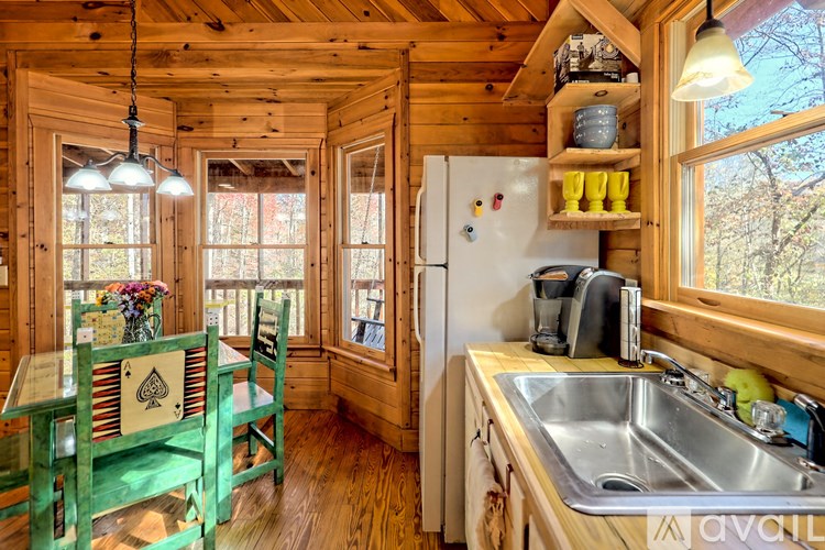 A kitchen with wooden walls and a white fridge.