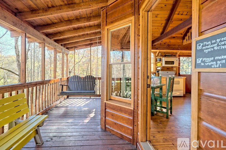 A wooden deck with a bench and a sign on the wall.