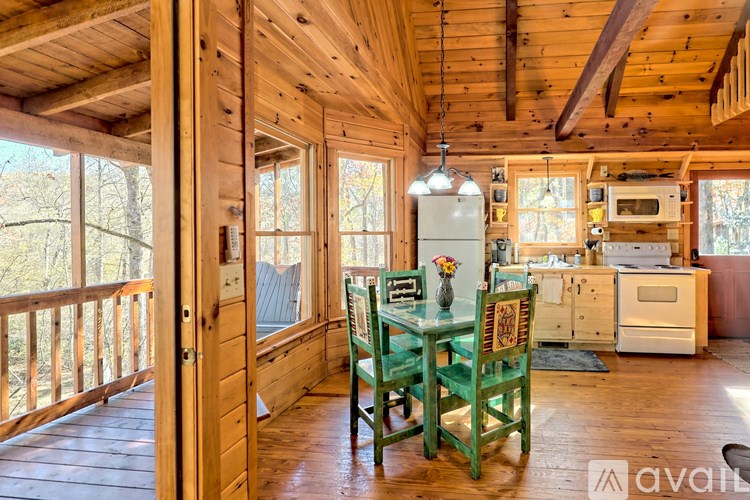 A wooden cabin with a table and chairs.