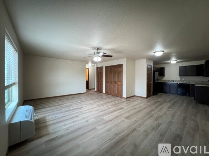 A room with a carpeted floor and a window.