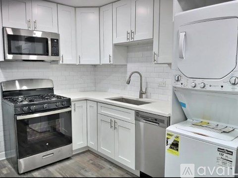 A kitchen with white cabinets and a stainless steel oven.