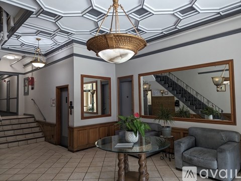 A living room with a staircase in the background.