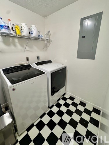 A small laundry room with a washer and dryer.