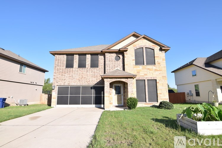 A house with a garage and a driveway is for sale.