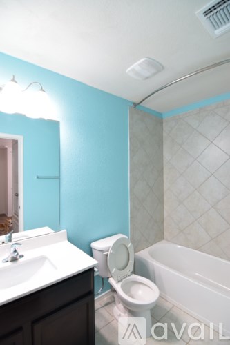 A room with a ceiling fan and carpeted floor.