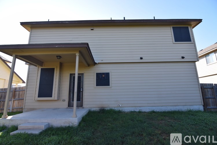 A two-story house with a front porch and a garage door.