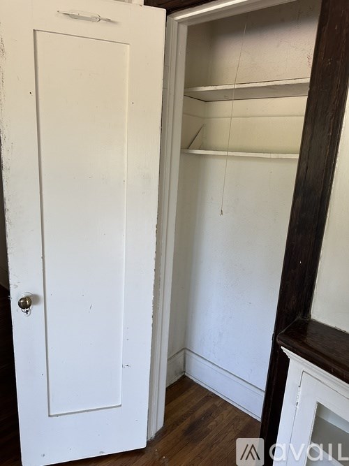 A white door with a white interior and a white wall.