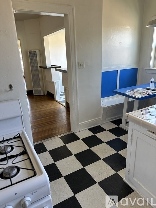 A kitchen with a black and white checkered floor.